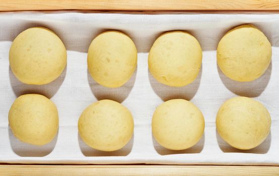 Balls of dough in wooden box  ,baking preparation