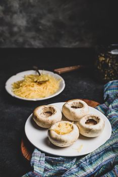 Stuffing button mushrooms with grated cheddar cheese