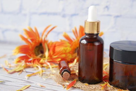 eucalyptus essential oils in a glass bottle and flower on table .