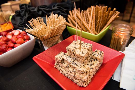 Rice crispy treat display with pretzel sticks.