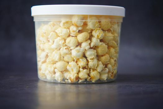 popcorn in a bowl on wooden des.
