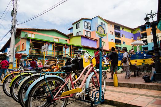 View of downtown Guatape, Colombia with colorful pastel bicycles and architecture.