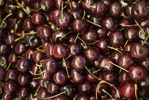 close up of cherry fruit display for sale at local store .