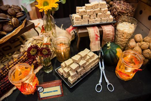 Festive autumn food spread with fudge flowers and leaf decor.