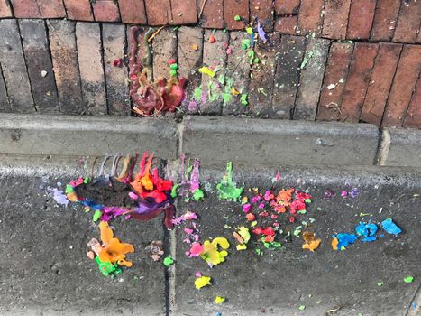 Colorful melted candle wax on the sidewalk after vigil in Bogota.