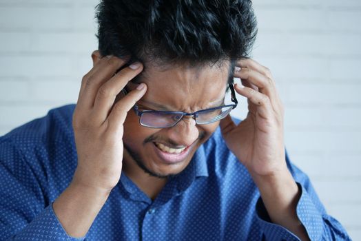 Depressed man feeling sick and worried about financial problem.