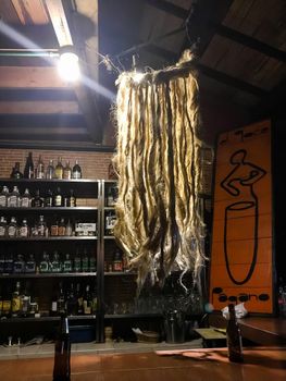 Dread lock hair chandelier hanging by a bar in Bogota, Colombia.