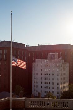 US flag flying half mast in Washington DC vertical crop