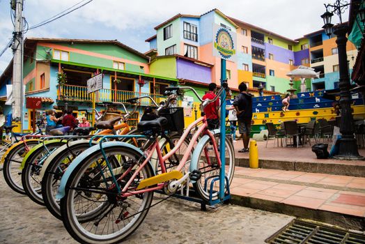View of downtown Guatape, Colombia with colorful pastel bicycles and architecture.