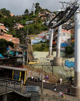 Many stairs in Medellin, Colombia with layers of homes and buildings. Vertical crop
