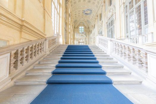 TURIN, ITALY - CIRCA JUNE 2021: The most beautiful Baroque staircase of Europe located in Madama Palace (Palazzo Madama). Interior with luxury marbles, windows and corridors.