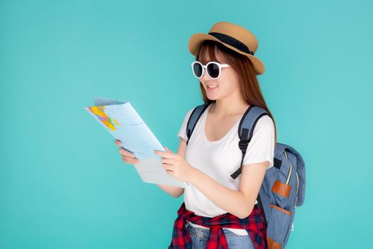 Beautiful happy young asian woman travel holding and looking a paper map isolated on blue background, asia girl search journey with direction in vacation trip with cheerful for leisure.