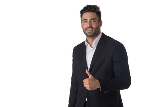 Portrait of young handsome business man in black suit smiling and showing thumbs up studio isolated on white background