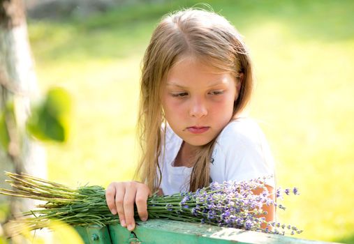 Portrait of little girl with lavender flower bouquet