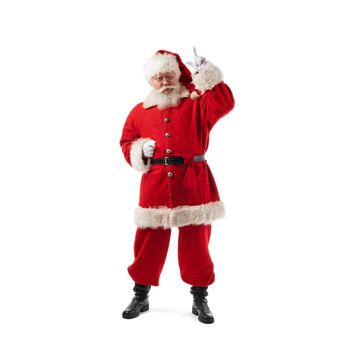 Full length portrait of Santa Claus pointing up studio isolated on white background