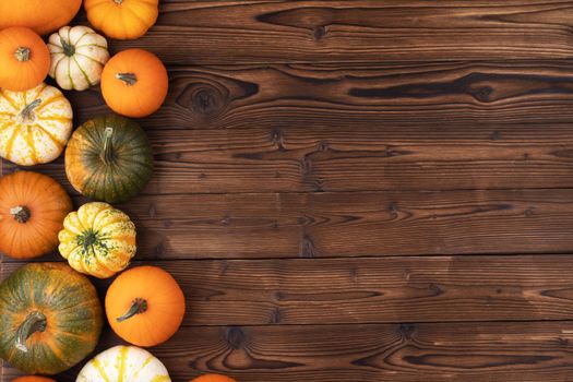 Many pumpkin top border over a rustic wood background