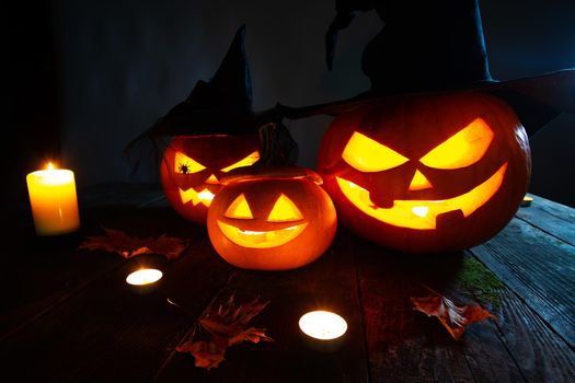 Still life of Halloween pumpkin lanterns pumpkins and hats decoration in candle light