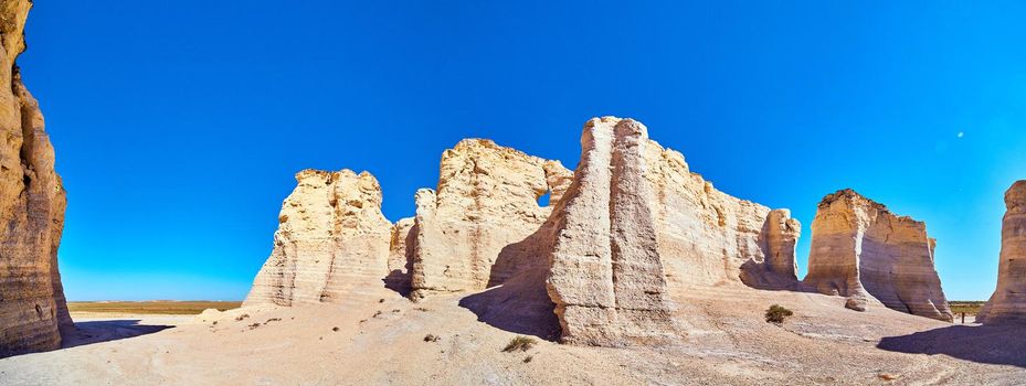 Image of Panorama of white and beige vertical rock monuments against blue sky