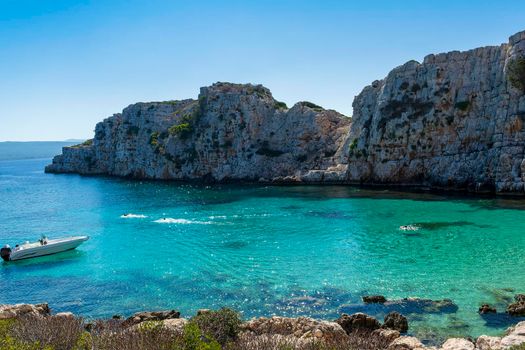 People swimming in the clear blue waters of Proti Island, near Marathopoli, Messinia at Peloponnese. The name of the island derives from the ancient sea god Proteus, son of Poseidon.