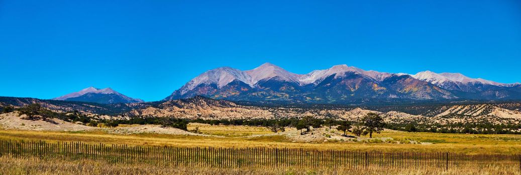 Image of Panorama of midwest mountain range in desert with simple wood fence in foreground