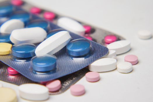 Close up of pills of blister pack on table .