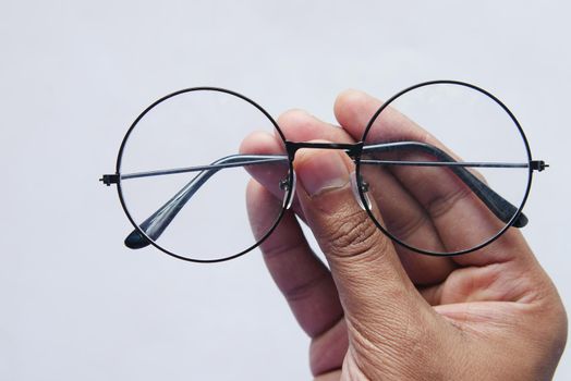 Close up of man hand holding eyeglass,