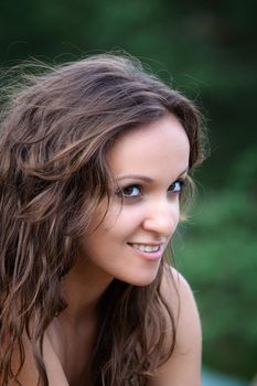 Portrait of emotional half-naked young woman on natural background