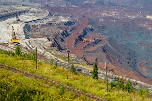 Concept of mineral development - panorama of operating ore mine, top view.