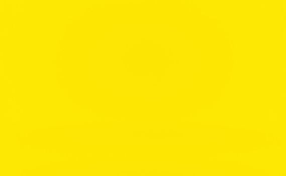 Abstract solid of shining yellow gradient studio wall room background