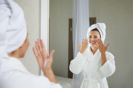 Young woman doing face building facial gymnastics self massage and rejuvenating exercises