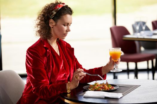 Cropped view of woman eating salad for lunch in luxury restaurant, Healthy lifestyle, diet concept
