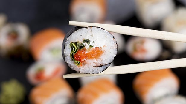close up chopsticks with sushi roll. Resolution and high quality beautiful photo