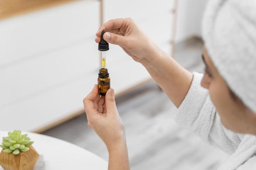 close up woman holding serum. Resolution and high quality beautiful photo