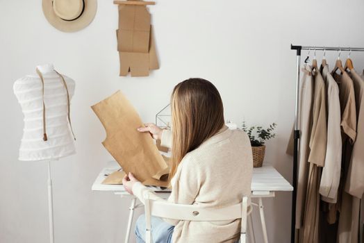back view female tailor with patterns hands. Resolution and high quality beautiful photo