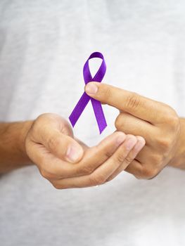 close up man holding up purple ribbon. Resolution and high quality beautiful photo