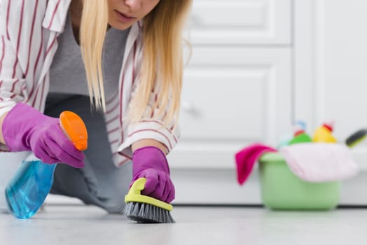 close up woman spray cleaning floor. Resolution and high quality beautiful photo