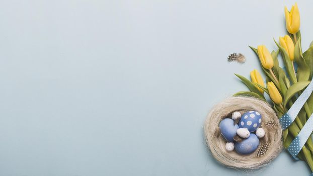 nest with colored eggs near tulips. Resolution and high quality beautiful photo