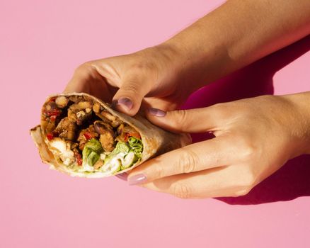 close up woman holding delicious burrito. Resolution and high quality beautiful photo