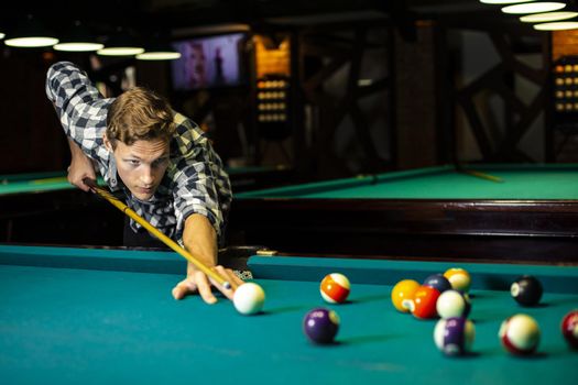 medium shot guy holding pool cue. Resolution and high quality beautiful photo