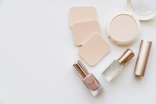 overhead view nail polish bottle lipstick sponge compact white background. Resolution and high quality beautiful photo