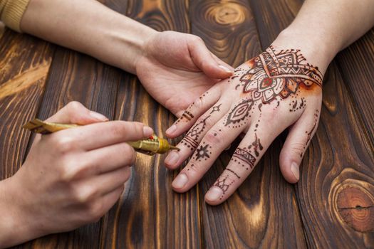 artist making mehndi womans hand. Resolution and high quality beautiful photo