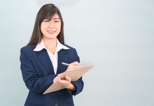 Portrait of Asian woman long hair and wearing suit  with clipboard and pen in hands thinking about success, isolated on white background