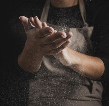 close up baker cleaning hands off flour. Resolution and high quality beautiful photo