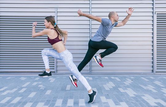 active sportive young male female athlete running jumping air. Resolution and high quality beautiful photo