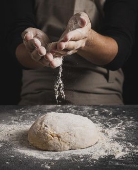 close up baker hands spreading flour. Resolution and high quality beautiful photo