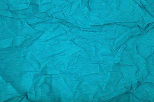Aqua blue crumpled paper texture background with space for text. Crumpled wrapping paper background. Concept of template for text with high resolution
