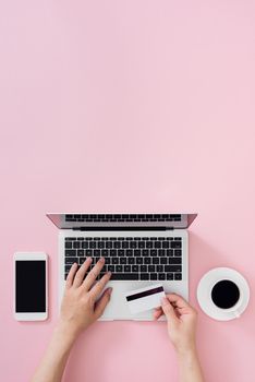 Top view of businessman office desk with credit card for online payment on laptop computer  flat lay on color background 