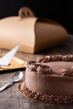 Piece of chocolate truffle cake on wooden table