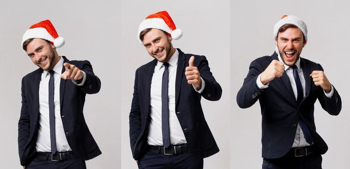 Handsome caucasian guy business suit and Santa hats white background studio smilie showing thumbs up. Business person Christmas mood Holiday mood Businessman positive emotions