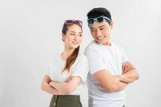 Cheerful hsppy man and woman with crossed hands standing back to back.